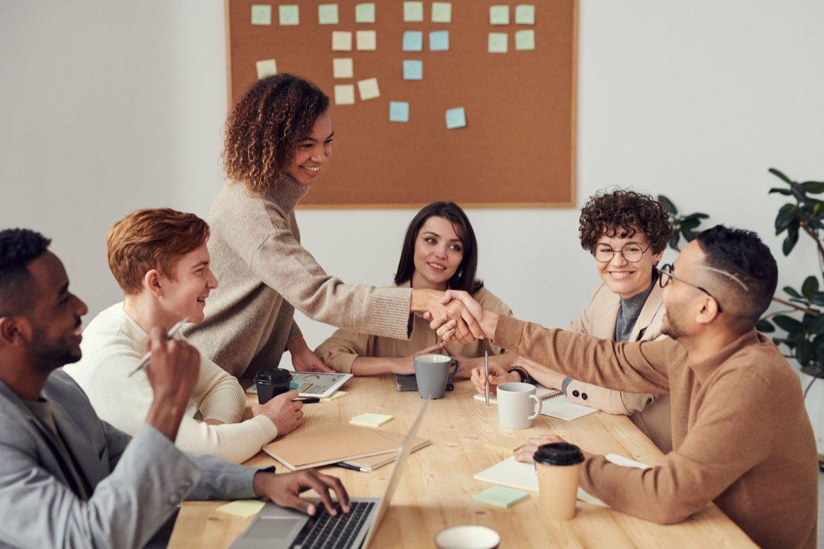 Marketing team collaborating around a table in a bright office